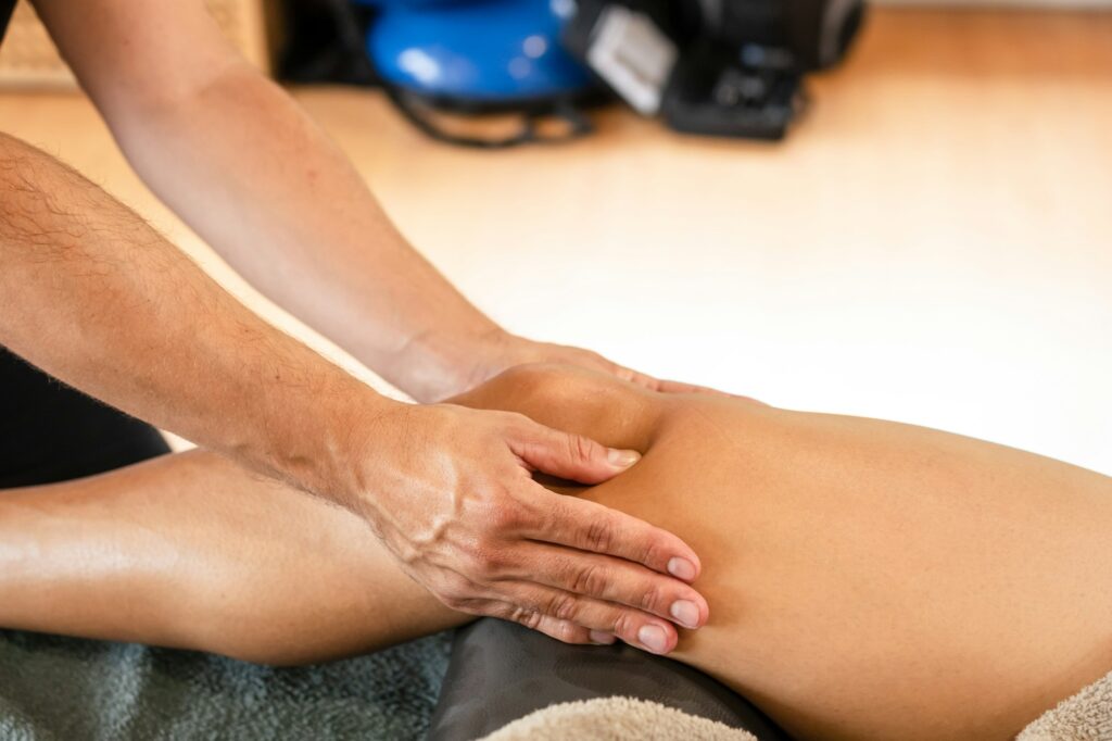Detail of the therapeutic knee massage and sports recovery osteopathy