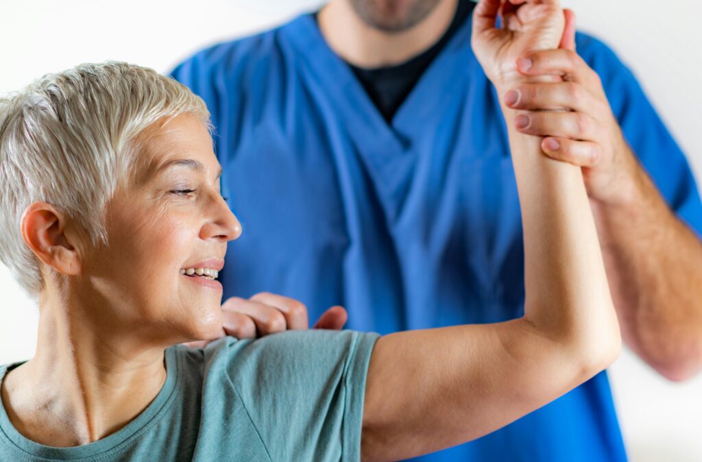 Therapist Checking Senior Woman’s Arm